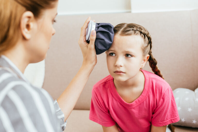 child with dyspraxia who got hurt being comforted by her mother