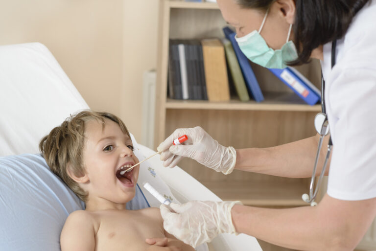 A woman testing a young boy for illness