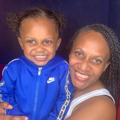 Venessa and her grandson, who is wearing a blue hoodie, with two buns on his head